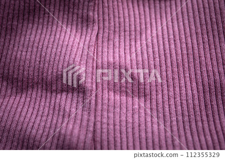 Close-up of purple knit with seam, ribbed, distinct texture, curved fabric Close-up of purple knit with seam, ribbed, distinct texture, curved fabric 112355329