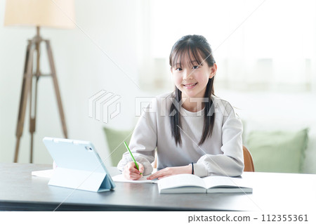 Portrait of a girl studying using a tablet Portrait of a girl studying using a tablet 112355361