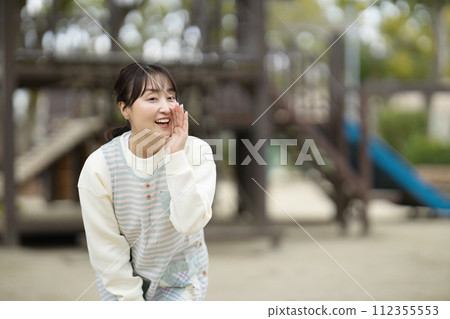Nursery teacher watching over children in the park 112355553