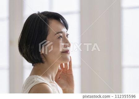 Woman in her early 50s profile beauty image portrait 112355596