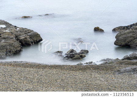 Walking by the seaside 112356513