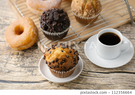 chocolate chip muffin with donut and coffee 112356664