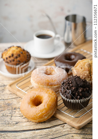 glazed donuts with coffee and muffins glazed donuts with coffee and muffins 112356671