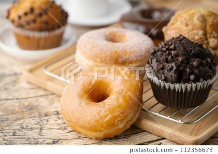 glazed donuts with coffee and muffins glazed donuts with coffee and muffins 112356673