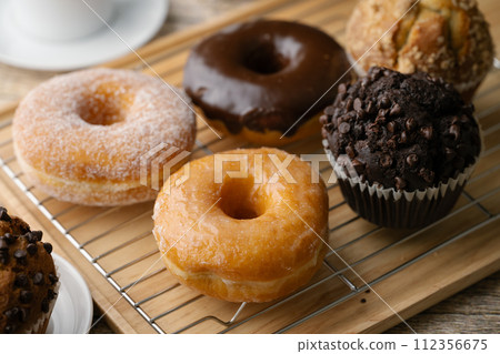 glazed donuts with coffee and muffins 112356675