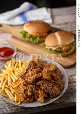fried chicken, chicken sandwich and fries fried chicken, chicken sandwich and fries 112356687