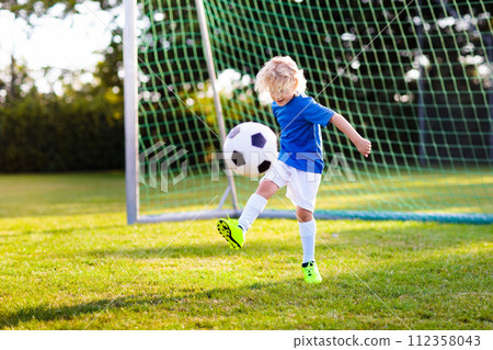 Kids play football. Child at soccer field. Kids play football. Child at soccer field. 112358043