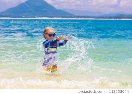 Kids playing on beach. Children play at sea. Kids playing on beach. Children play at sea. 112358044