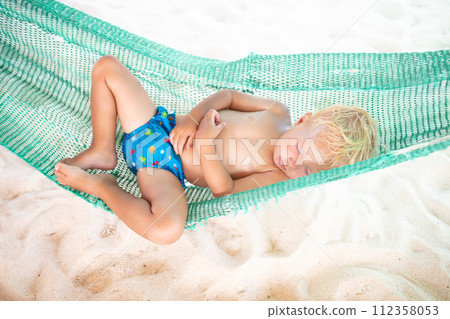Baby sleeping on tropical beach. Child in hammock. Baby sleeping on tropical beach. Child in hammock. 112358053