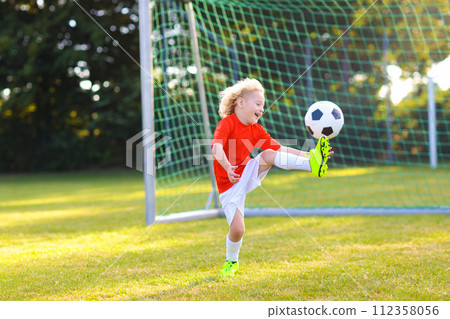 Kids play football. Child at soccer field. Kids play football. Child at soccer field. 112358056
