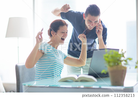 Man and woman working at laptop in modern office 112358213