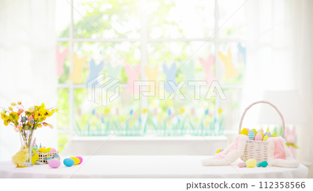 Easter home decoration. Eggs basket and bunny. 112358566
