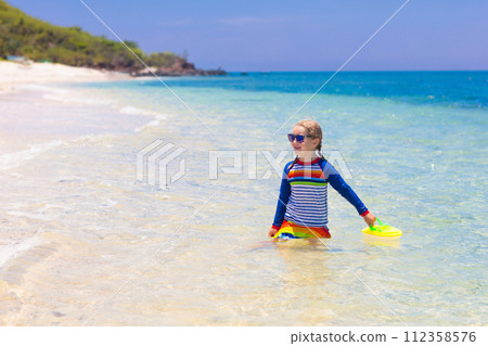 Kids playing on beach. Children play at sea. Kids playing on beach. Children play at sea. 112358576