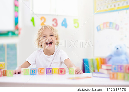 Child learning letters. Kid with wooden abc blocks Child learning letters. Kid with wooden abc blocks 112358578