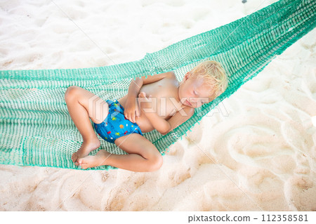 Baby sleeping on tropical beach. Child in hammock. Baby sleeping on tropical beach. Child in hammock. 112358581