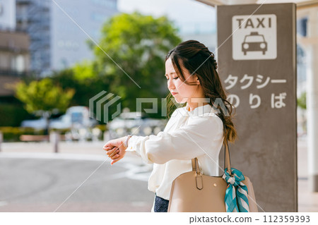 Business woman waiting for a taxi at the taxi stand (slow, late, irritated) 112359393