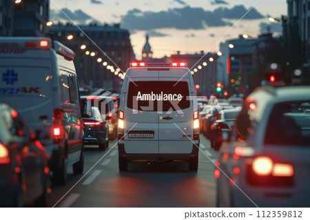 Ambulance with lights on driving down road, Snapshot of speeding ambulance on job 112359812