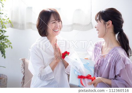 Mother's Day: Mother receiving carnations and presents 112360516