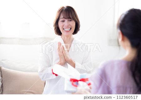 Mother's Day: Mother receiving carnations and presents 112360517
