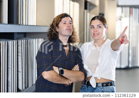 Nice couple in hardware store looking to buy bathroom tiles 112361129