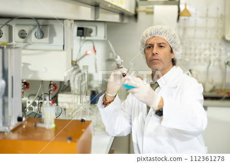Confident man technician working in research laboratory 112361278