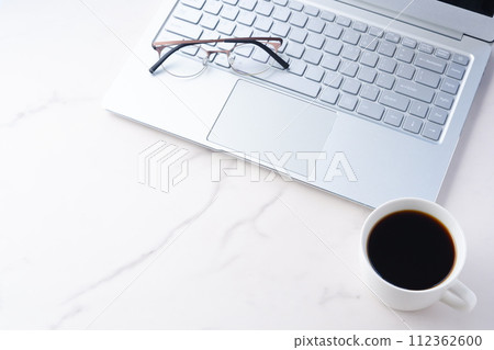 Image of desk work on a laptop while drinking coffee 112362600