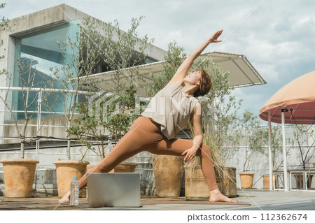 Female yoga teacher/yoga instructor who does online yoga/remote yoga Female yoga teacher/yoga instructor who does online yoga/remote yoga 112362674