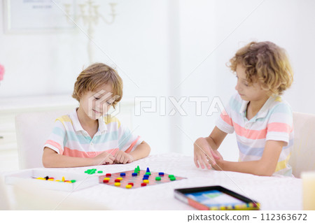 Family playing board game. Kids play. Family playing board game. Kids play. 112363672