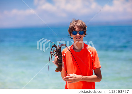 Boy catching fish. Kids fishing on tropical beach. Boy catching fish. Kids fishing on tropical beach. 112363727