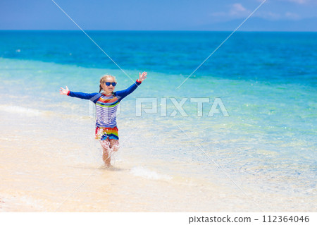 Kids playing on beach. Children play at sea. Kids playing on beach. Children play at sea. 112364046