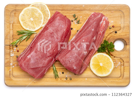 Fresh tuna Fish steak on a wooden cutting serving board isolated on a white background 112364327