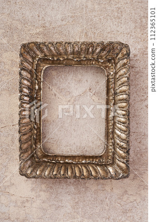 Antique picture frame hanging on marble background Antique picture frame hanging on marble background 112365101