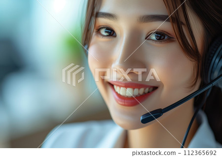 "AI-generated image" of a young female operator wearing a headset in the office 112365692