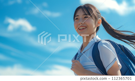 Smiling high school girl looking up at the blue sky "AI generated image" 112365701
