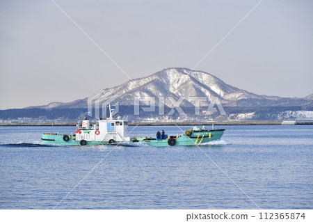 Photographing the scenery of a small tanker at Hakodate Port in Hakodate City, Hokkaido in early spring 112365874
