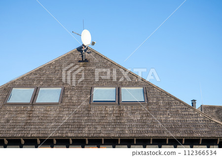 Wood chip roof and skylights. Blue sky Wood chip roof and skylights. Blue sky 112366534