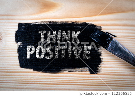 Think Positive Concept. Black paint and brush on wood texture background Think Positive Concept. Black paint and brush on wood texture background 112366535