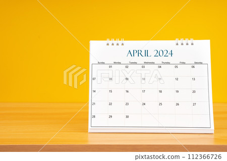 April 2024, Monthly desk calendar for 2024 year on wooden table. 112366726