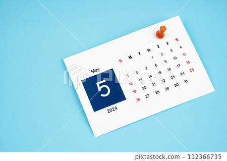 May 2024 calendar page with push pin on blue background. May 2024 calendar page with push pin on blue background. 112366735