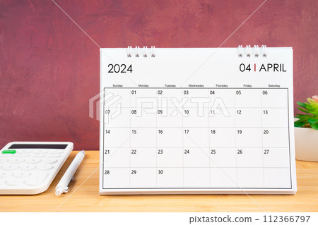 April 2024 white calendar and calculator with pen. April 2024 white calendar and calculator with pen. 112366797