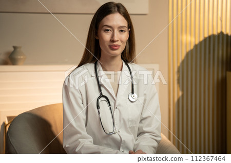 Young Female Doctor Smiling During a Consultation in a Modern Clinic Young Female Doctor Smiling During a Consultation in a Modern Clinic 112367464
