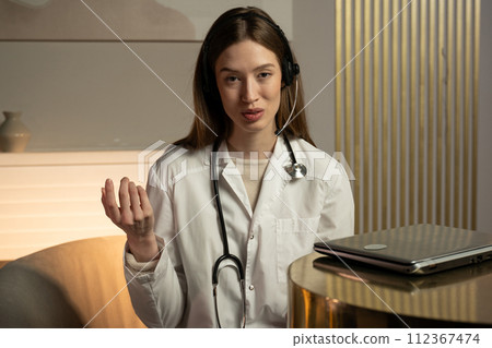 Young Female Doctor Consulting Patient Via Video Calling 112367474