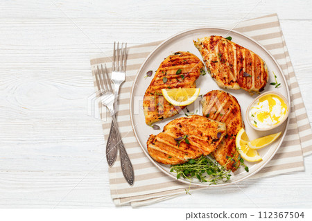 juicy grilled chicken cutlets on plate, top view 112367504
