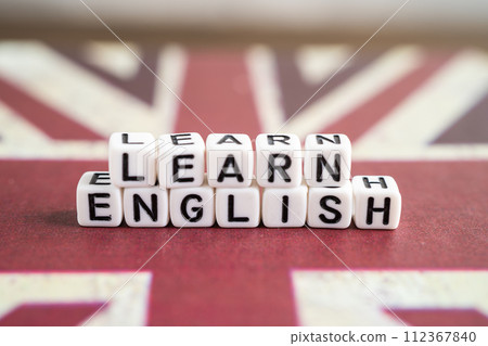 Word Learn English on book with United Kingdom flag, learning English language courses concept. Word Learn English on book with United Kingdom flag, learning English language courses concept. 112367840