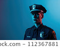 Studio photo of a policeman with his cap on a blue background 112367881