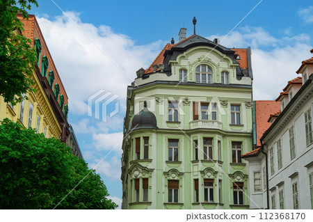 Historic low rise buildings with vivid colors against a blue sky with clouds at the city center of Bratislava, Slovakia. Historic low rise buildings with vivid colors against a blue sky with clouds at the city center of Bratislava, Slovakia. 112368170