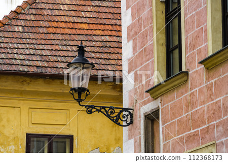 Traditional iron lamp lantern on a wall of historic buildings in the Old Town of Bratislava, Slovakia. 112368173