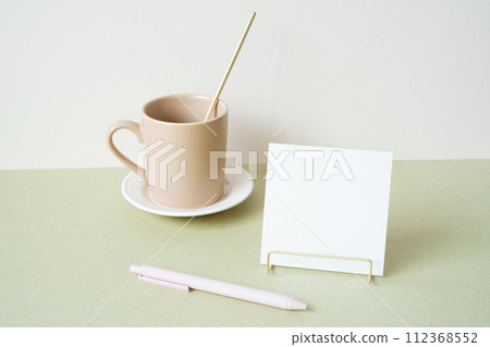 Blank memopad with holder, pen, mug cup on desk. white ivory background. workspace office stationery 112368552