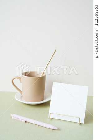 Blank memopad with holder, pen, mug cup on desk. white ivory background. workspace office stationery 112368553