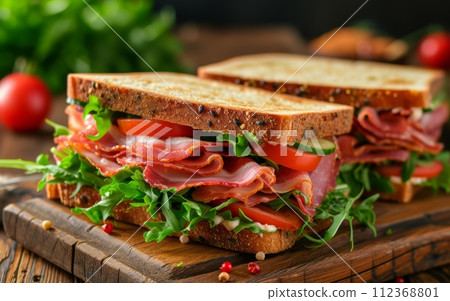 sandwiches with bacon, salami, prosciutto and fresh vegetables. Club sandwich concept sandwiches with bacon, salami, prosciutto and fresh vegetables. Club sandwich concept 112368801